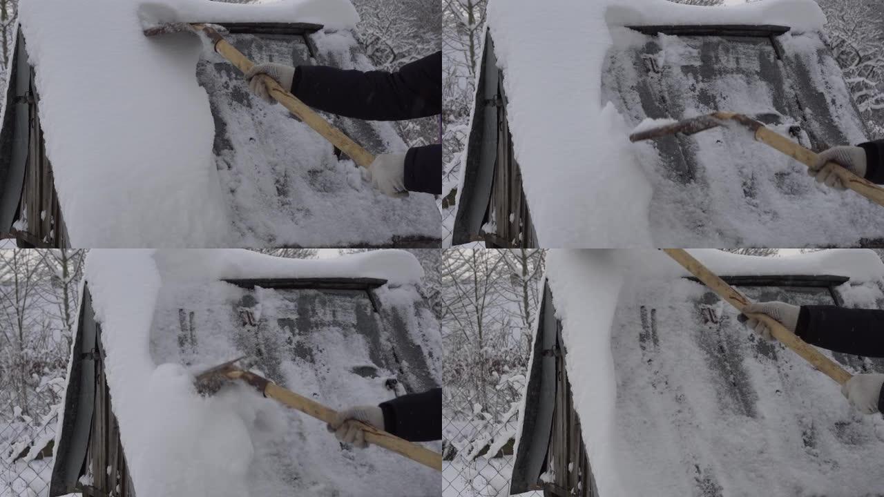 一个男人用铁锹从村里的井里清理雪，很多雪，冬天在村里