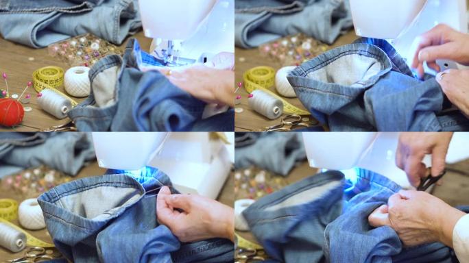 用缝纫机缝制牛仔牛仔裤。用缝纫机修理牛仔裤。