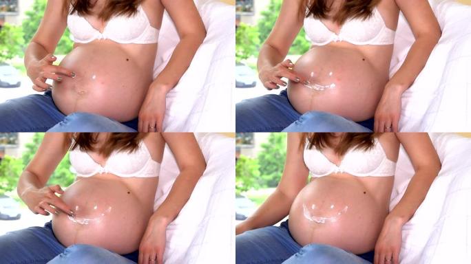 孕妇肚子上的手指画微笑。