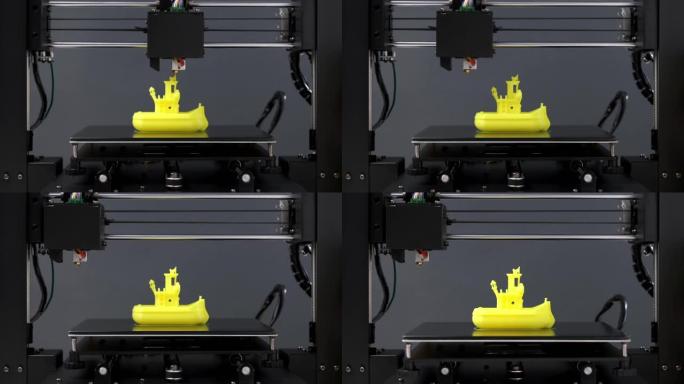 3D打印机小雕像玩具船从黄色塑料特写打印。清除打印头和打印机工作平台的移动。现代技术3D打印的潜力。