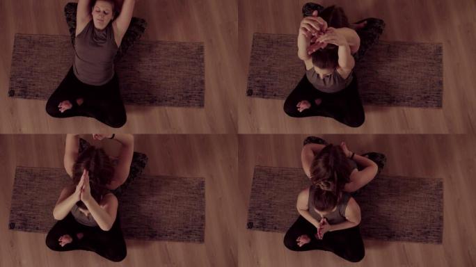 情侣瑜伽。两个女人背靠背坐着做瑜伽练习
