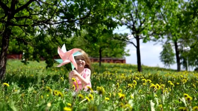 可爱的小女孩在春天阳光明媚的日子里玩蒲公英。
