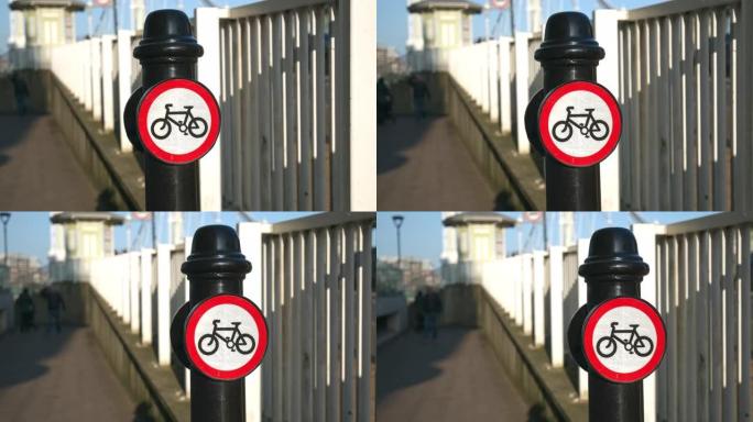 在4k的公园中，禁止骑自行车超过此点交通标志。骑自行车的人下马。