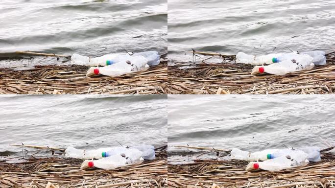 河岸上的塑料垃圾和塑料袋漂浮在水面上。封闭链的污染。不负责任地处理垃圾