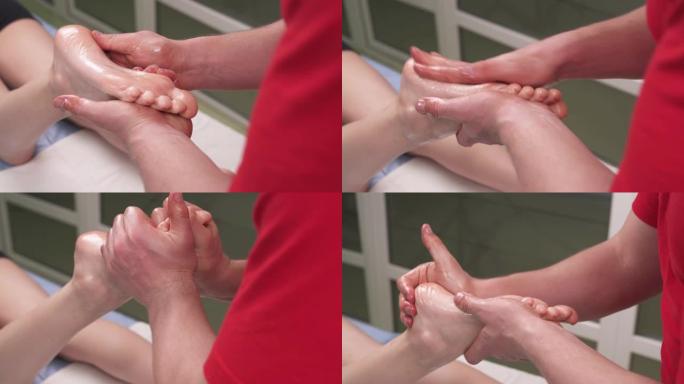 治疗师给病人做指压按摩。他用力压入女人的足弓和足部进行深层组织按摩。运动和康复概念