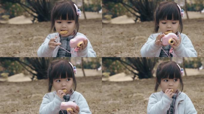 可爱的中国女孩在公园吃早餐和野餐