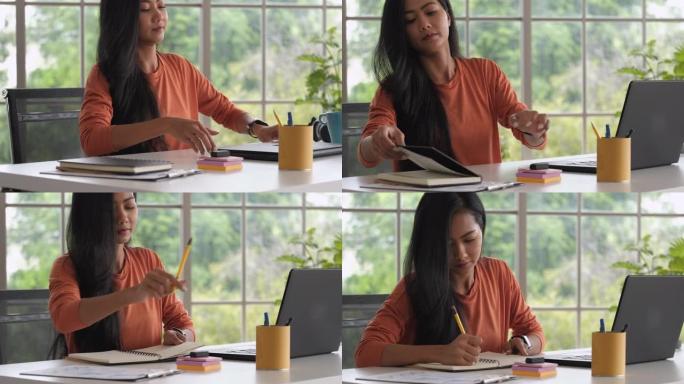 亚洲女性打开笔记本电脑从家里开始工作。新的正常办公室生活方式