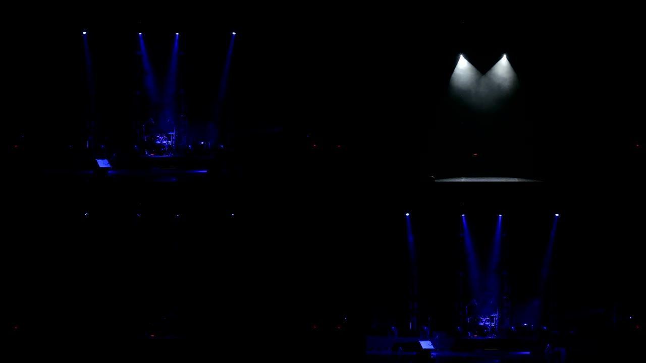 蓝色聚光灯照亮黑暗中空荡荡的舞台上的鼓。