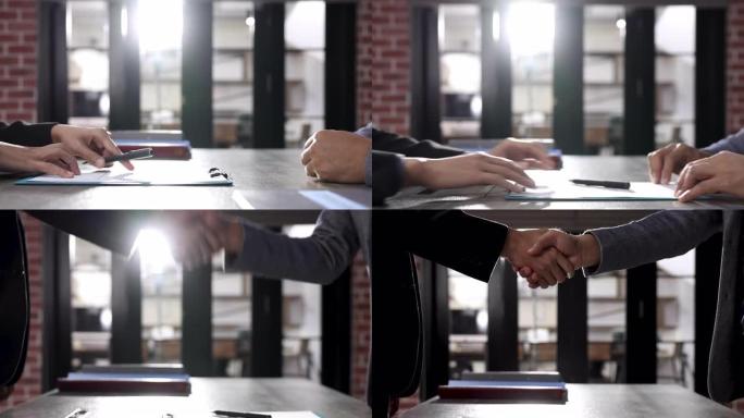 商业伙伴，两名商人在签订联合合同后握手。