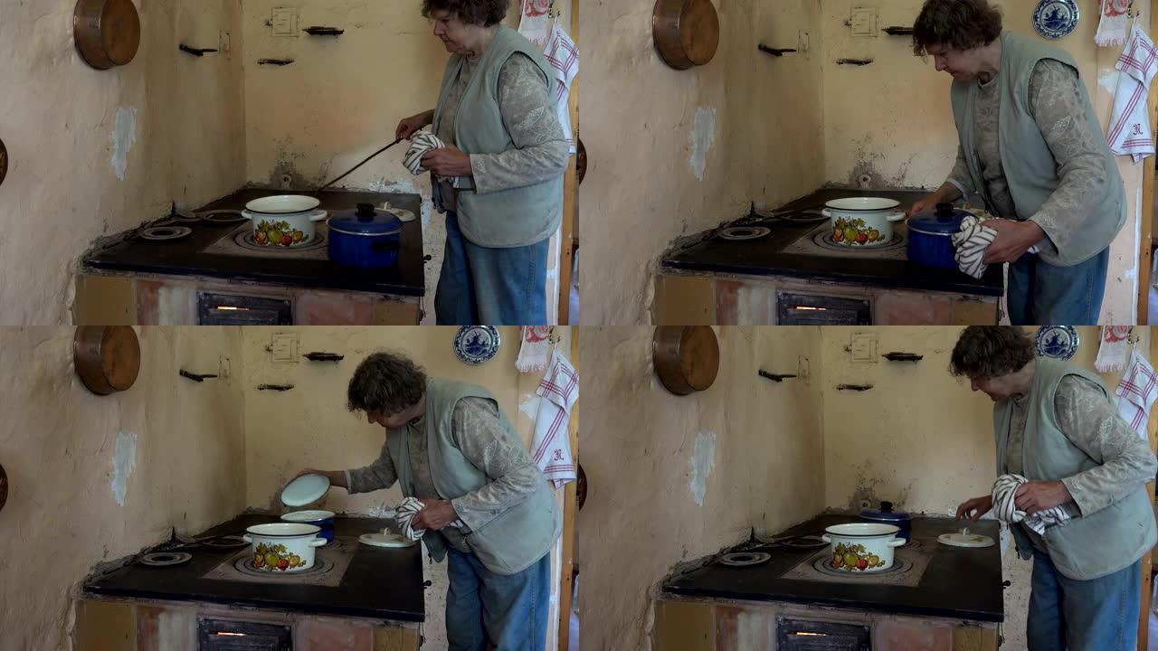 祖母女人在旧炉火上的锅里做饭。4K