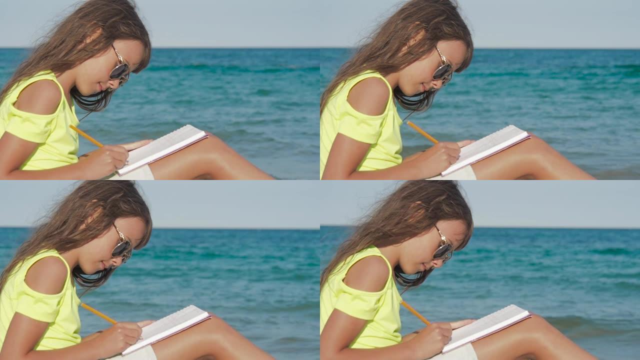 小女孩在海边写日记。