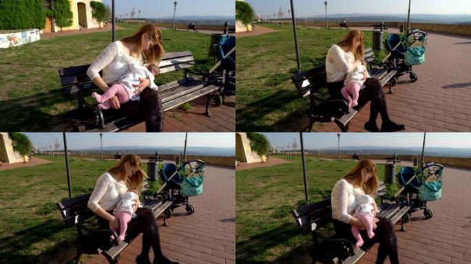 母亲在公园里母乳喂养婴儿