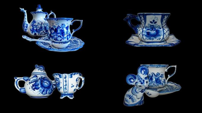 黑色背景上俄罗斯传统Gzhel风格的水壶、茶碟和茶匙茶杯。Gzhel-俄罗斯民间陶瓷工艺和生产瓷器
