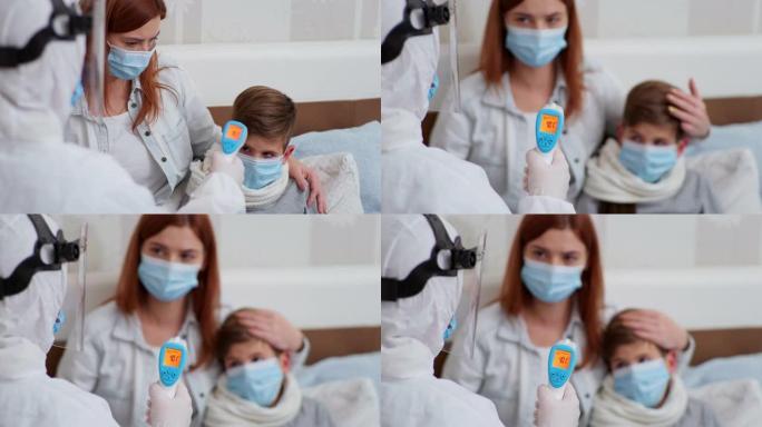 冠状病毒，穿着防护服的护士卫生工作者在家庭检查期间治疗小男性患者并测量摄氏高温