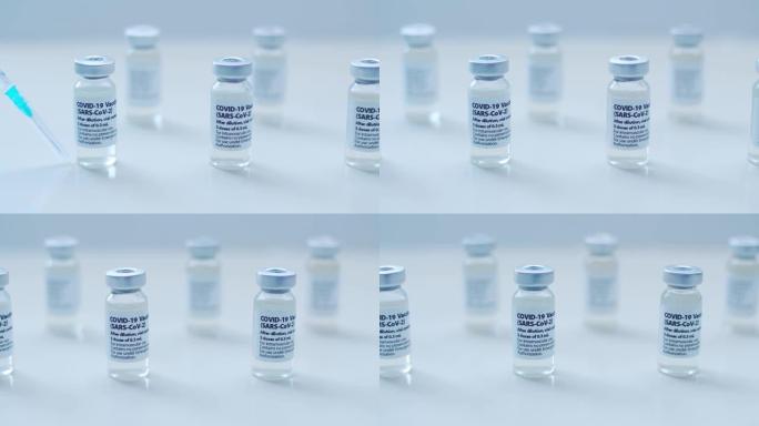 护士手持Covid-19疫苗小瓶和注射器，背景清晰。概念:预防冠状病毒。