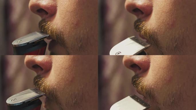 男子用电动剃须刀刮掉胡须和胡须
