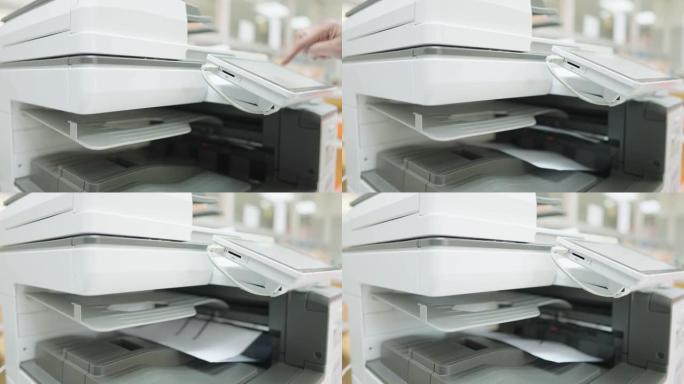 员工正在办公室复印机使用复印纸。