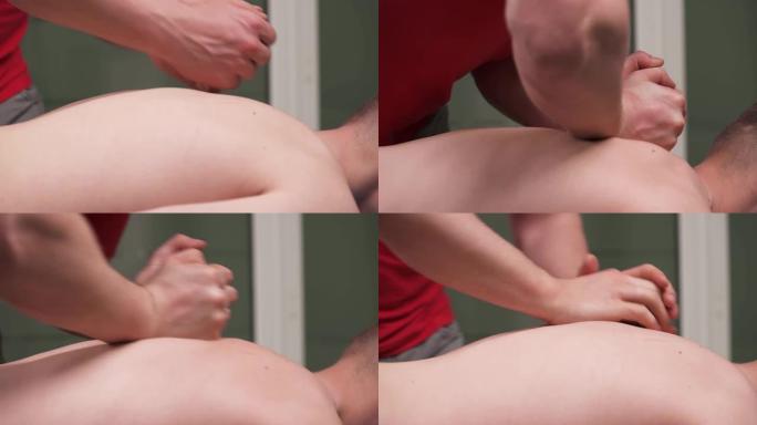 右手举起手动治疗师进行背部按摩的镜头。深层组织按摩。替代医学和损伤康复。