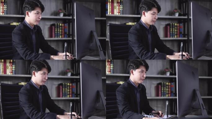 亚洲商人在办公桌上使用笔记本电脑。