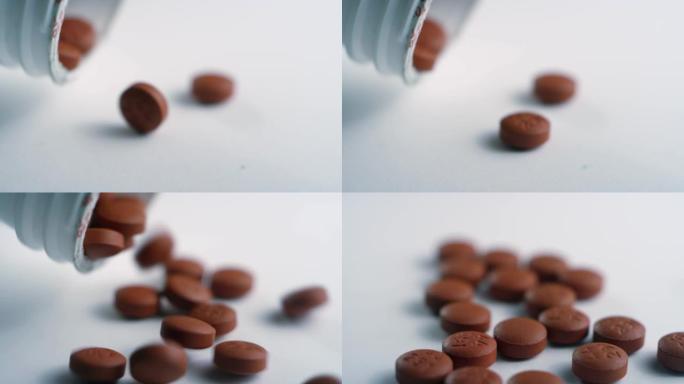 棕色布洛芬药丸的特写镜头从白色表面上的药瓶中倒出