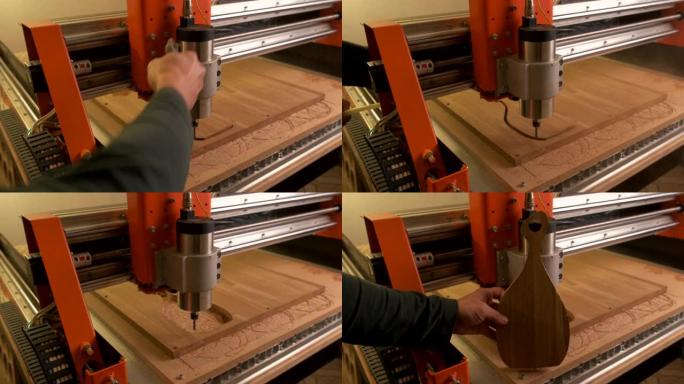 一位大师级的木雕师在数控木工机床中吹走成品切菜板上的灰尘。