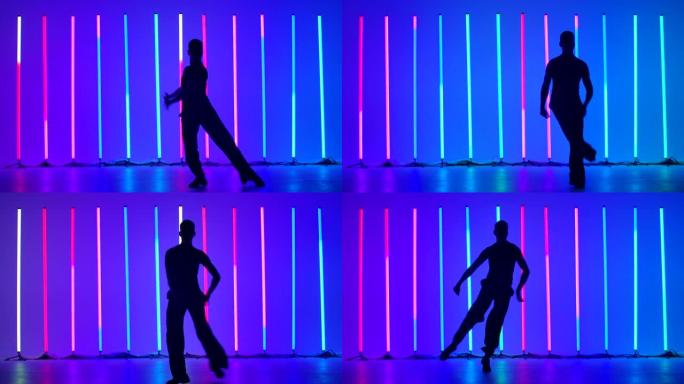 在明亮的彩色霓虹灯的背景下，一个年轻人在工作室里跳舞伦巴舞的黑暗剪影。这个家伙制定了舞蹈，步骤，转弯