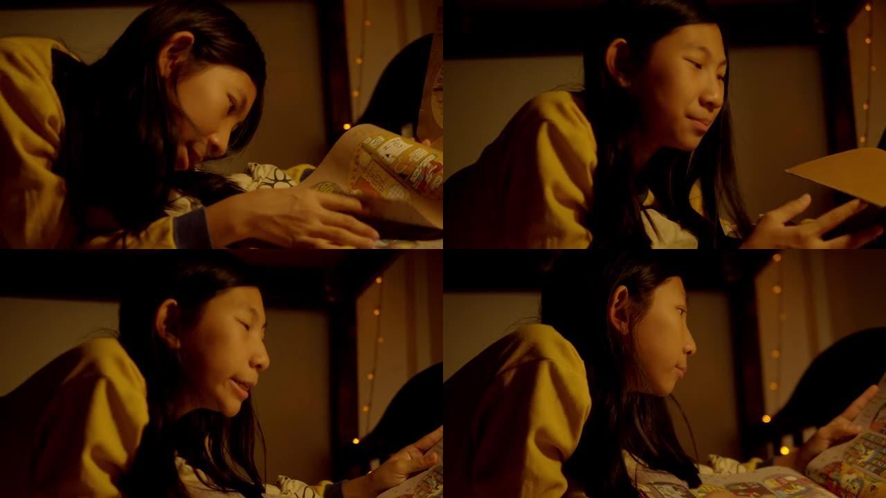 亚洲女孩穿着黄色毛衣躺在床上，晚上睡觉前看书，生活理念。