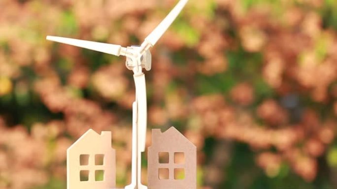 能源未来替代，电力可再生/清洁电能概念。家用/风力涡轮机，显示在橙色背景上使用绿色能源。自然或环境保