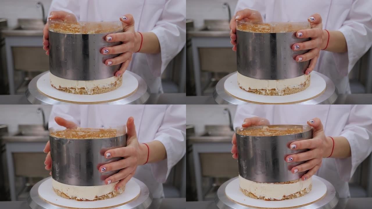糕点厨师准备蛋糕的特写镜头，取出金属圆形。