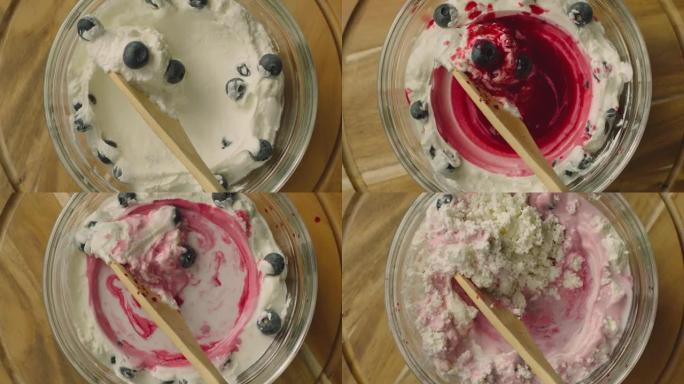 酸奶自制过程。制作新鲜的草莓和蓝莓甜点。滚动木板。延时拍摄。准备早餐。混合乳制品。用相机镜头移动勺子