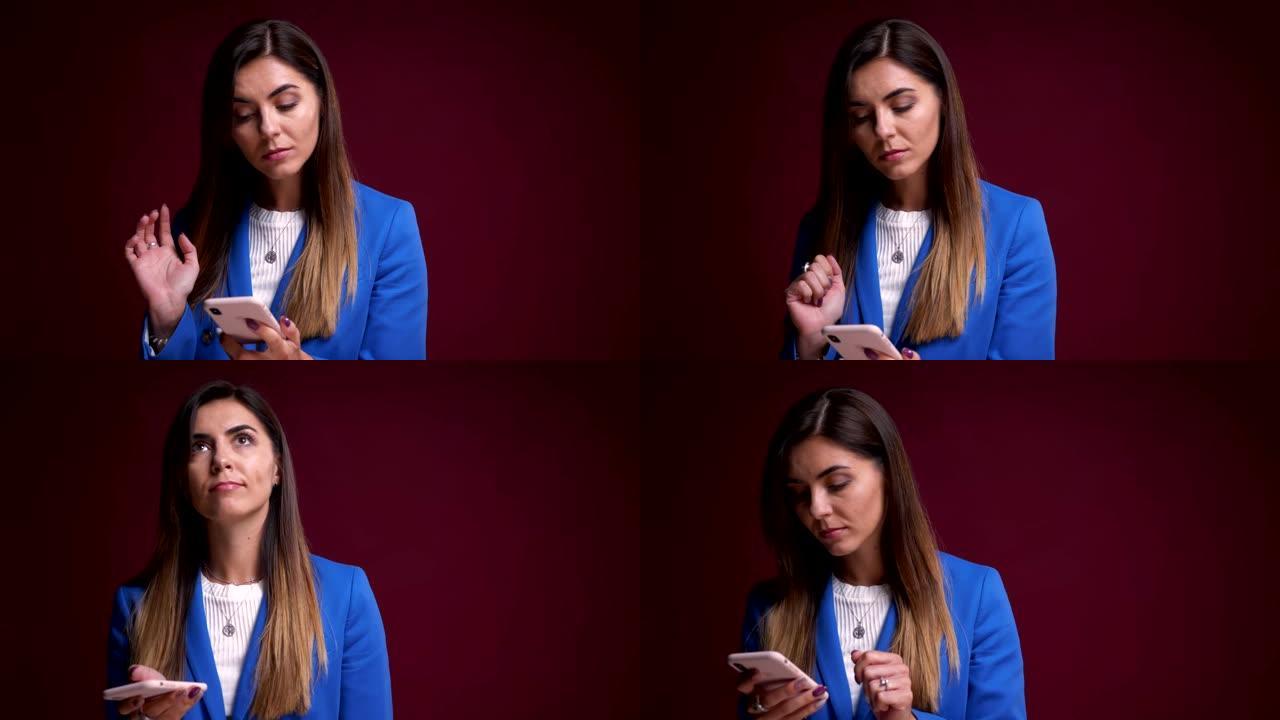 现代高加索女性在手机上打字并在镜头前思考的特写肖像