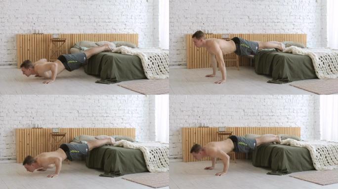 体格健壮的年轻人在家床上做俯卧撑运动，侧视