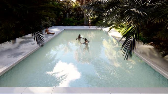 美丽的游泳池，有沐浴的人，在晴朗的晴天在一个失落的热带岛屿上。循环逼真的3D动画。