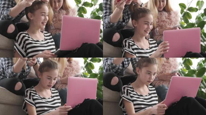 十几岁的女孩在笔记本电脑和手机上浏览社交媒体内容