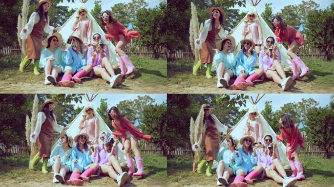 一群年轻的亚洲朋友穿着五颜六色的休闲装露营或野餐快乐的乐趣一起在花园青少年女性享受瞬间笑在他们的帆布