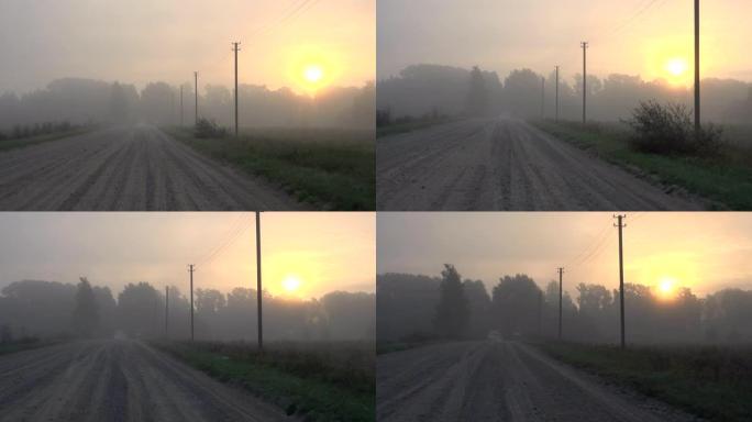 汽车在浓雾中行驶乡村碎石路。秋天早晨的薄雾日出。4K