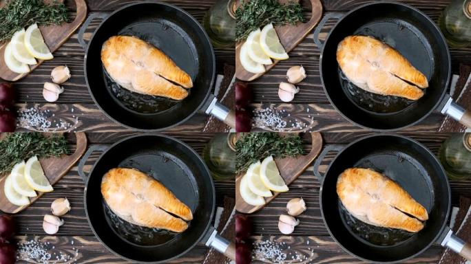 电影-在煎锅里煮鲑鱼牛排鱼。运动照片。