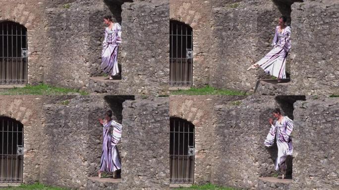 芭蕾舞女演员在一座古老城堡的废墟附近的大自然中跳舞