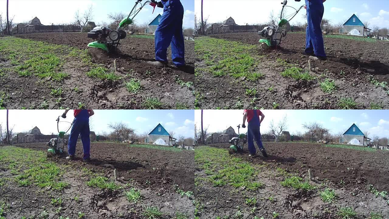 人类用耕作机在花园里耕种土地，为播种准备土壤