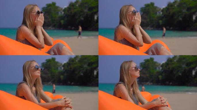 年轻女子坐在热带海滩上的充气沙发上咳嗽。旅行病概念