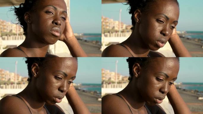 沮丧孤独的年轻非洲黑人妇女思考 -- 户外