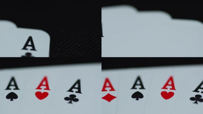 当扑克牌从侧面慢慢露出时，所有四个ace hearths diamonds空间交叉的扑克牌的近距离微