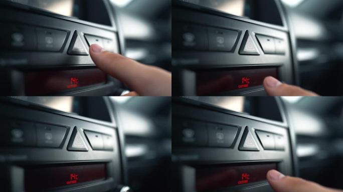 无法识别的人的手指按下警报按钮-汽车中的紧急信号。