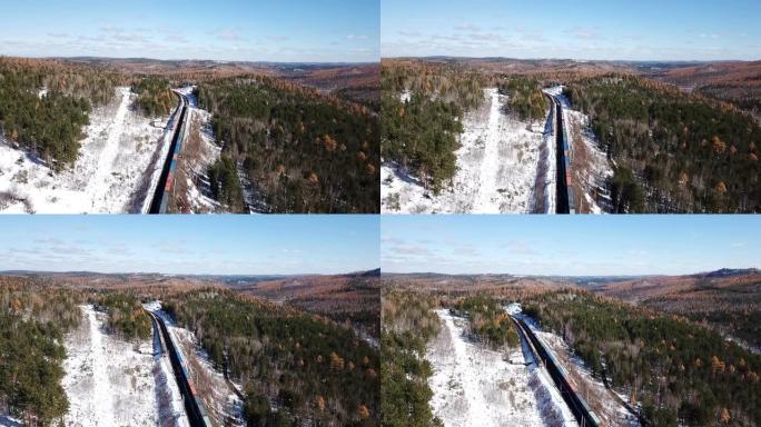 冬日空中无人机跟随贝加尔湖附近的西伯利亚铁路乘客旅游列车。电影专业镜头。高海拔