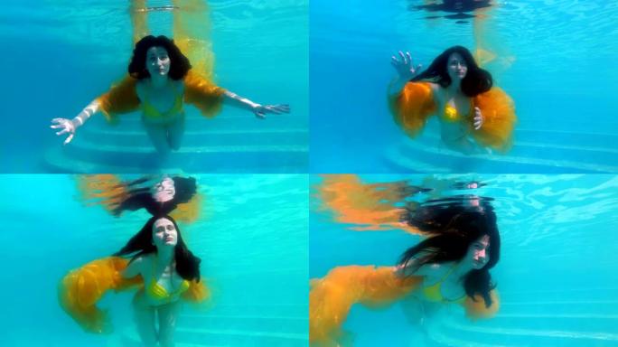 一个梦幻般的女孩穿着黄色泳衣，在游泳池的水面下，在镜头前游泳和摆姿势，手里拿着一块黄色的布，在阳光明