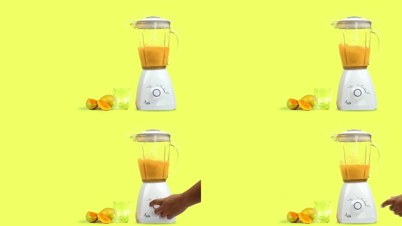 带有搅拌器的芒果汁，在黄色背景上隔离