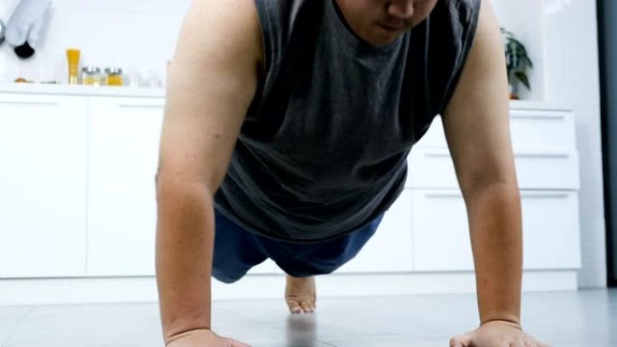 超重男性出汗做俯卧撑减肥锻炼