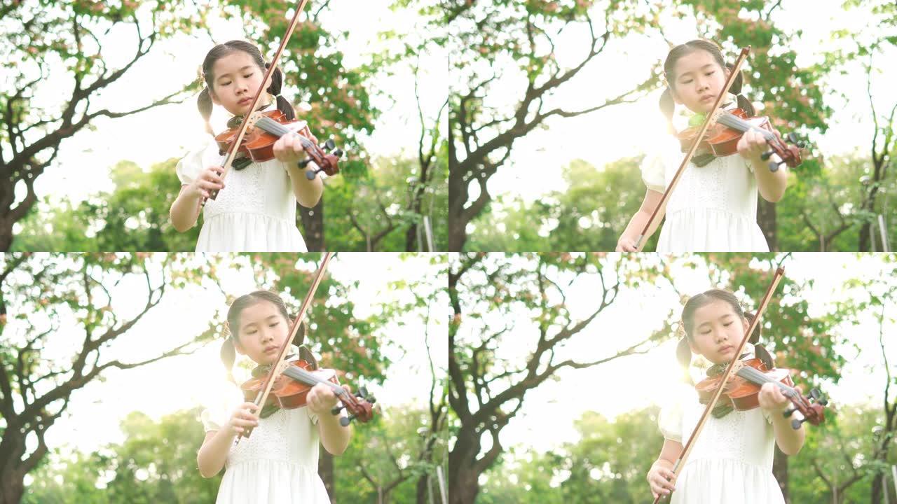 亚洲小女孩拉小提琴。乐器的概念，自我学习和生活体验。4K分辨率和慢镜头。