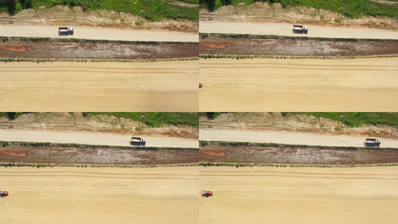 半卡车在沙滩上行驶的Tod向下视图。在建筑工地上。鸟瞰图