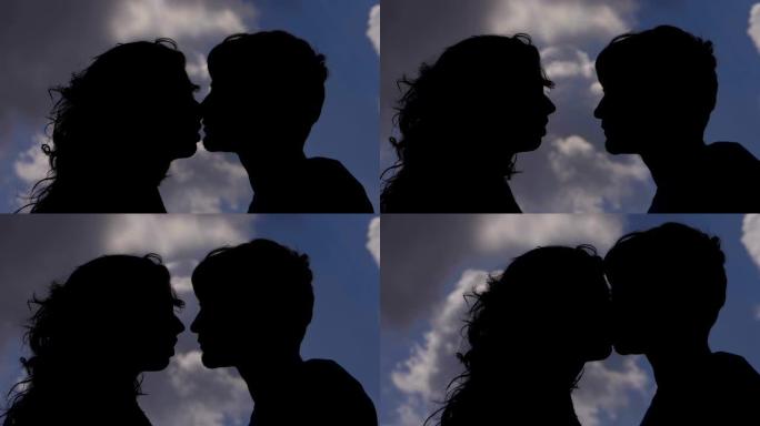 年轻恋人在夏日日落时亲吻的剪影。浪漫，爱情-缓慢的运动
